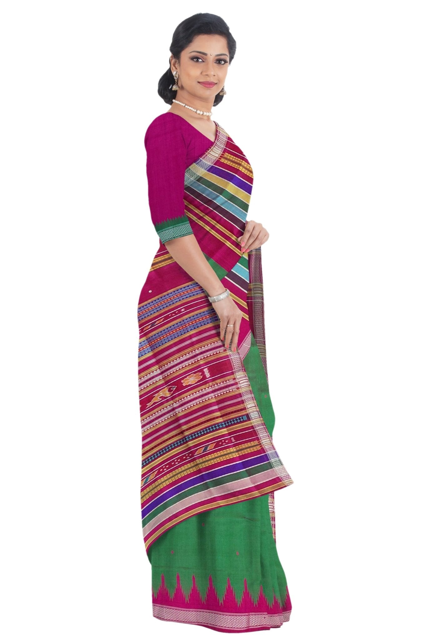 A woman modeling a traditional Indian saree with a magenta pink blouse and a green saree body featuring a vibrant multicolor striped border and a pink zari border. Side profile with blouse.