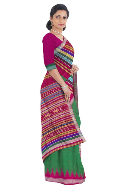 A woman modeling a traditional Indian saree with a magenta pink blouse and a green saree body featuring a vibrant multicolor striped border and a pink zari border. Side profile with blouse.