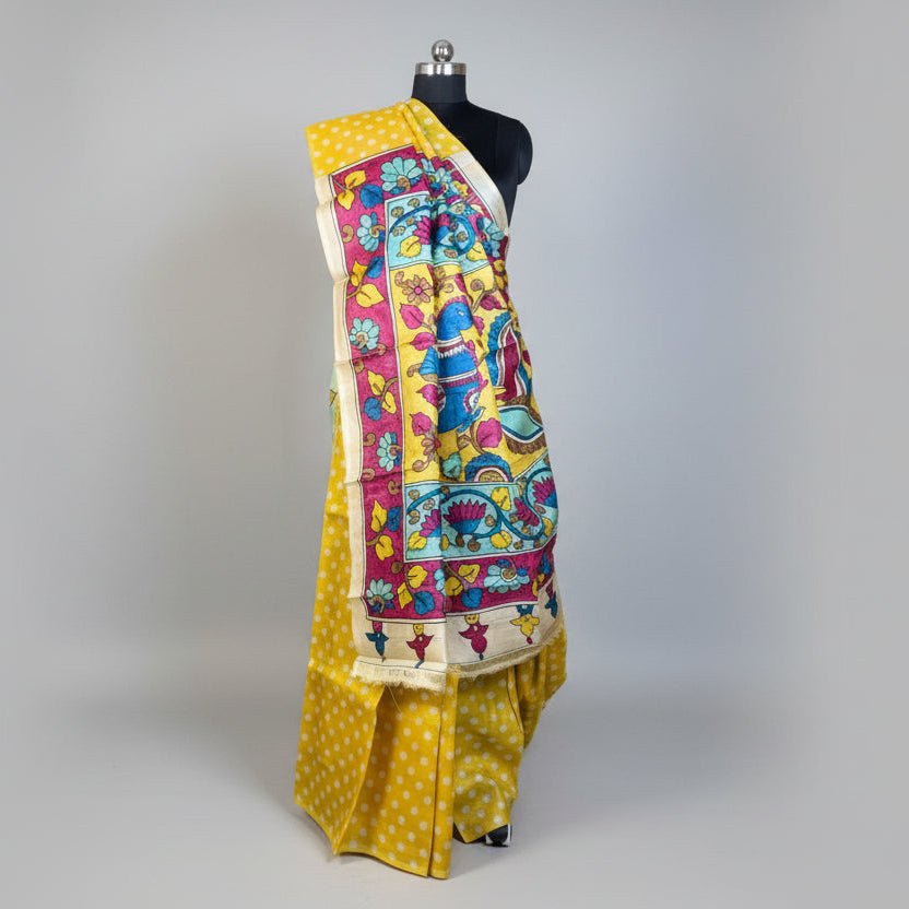 Colorful saree with a traditional design on a mannequin against a gray background