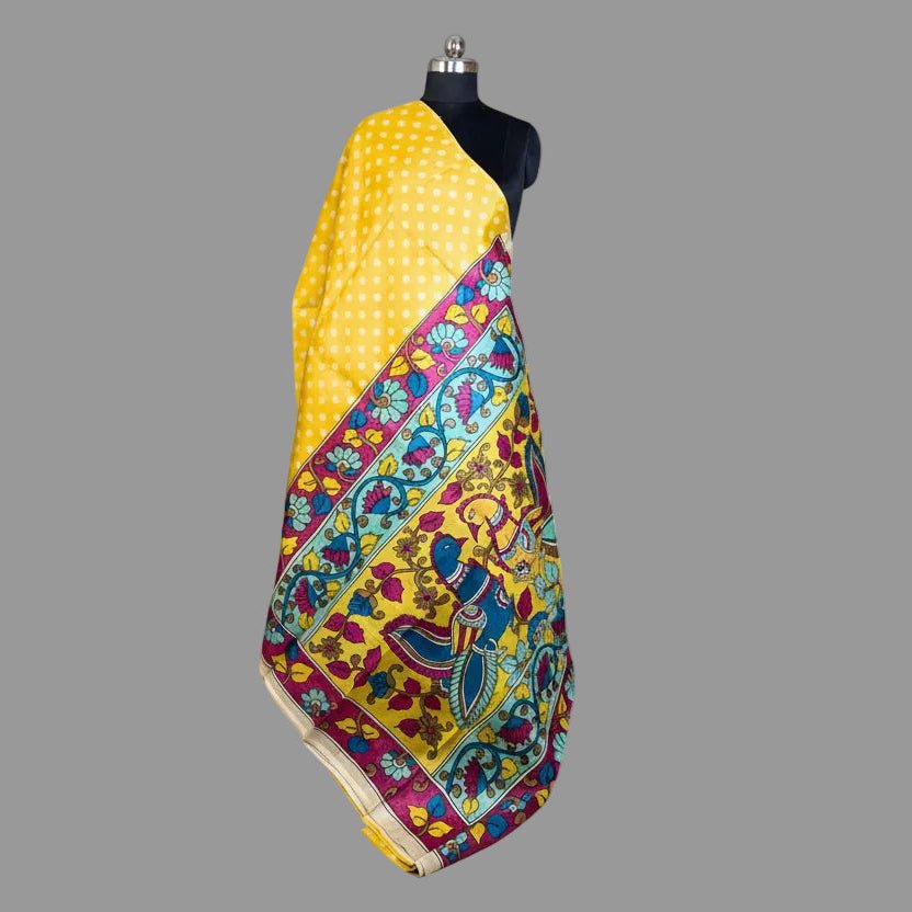 Colorful saree with a yellow background on a mannequin against a gray background